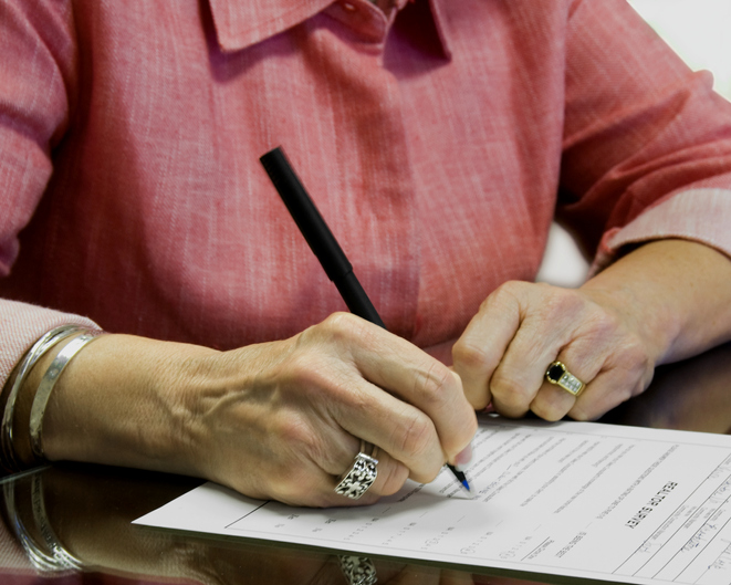 female signing a legal document